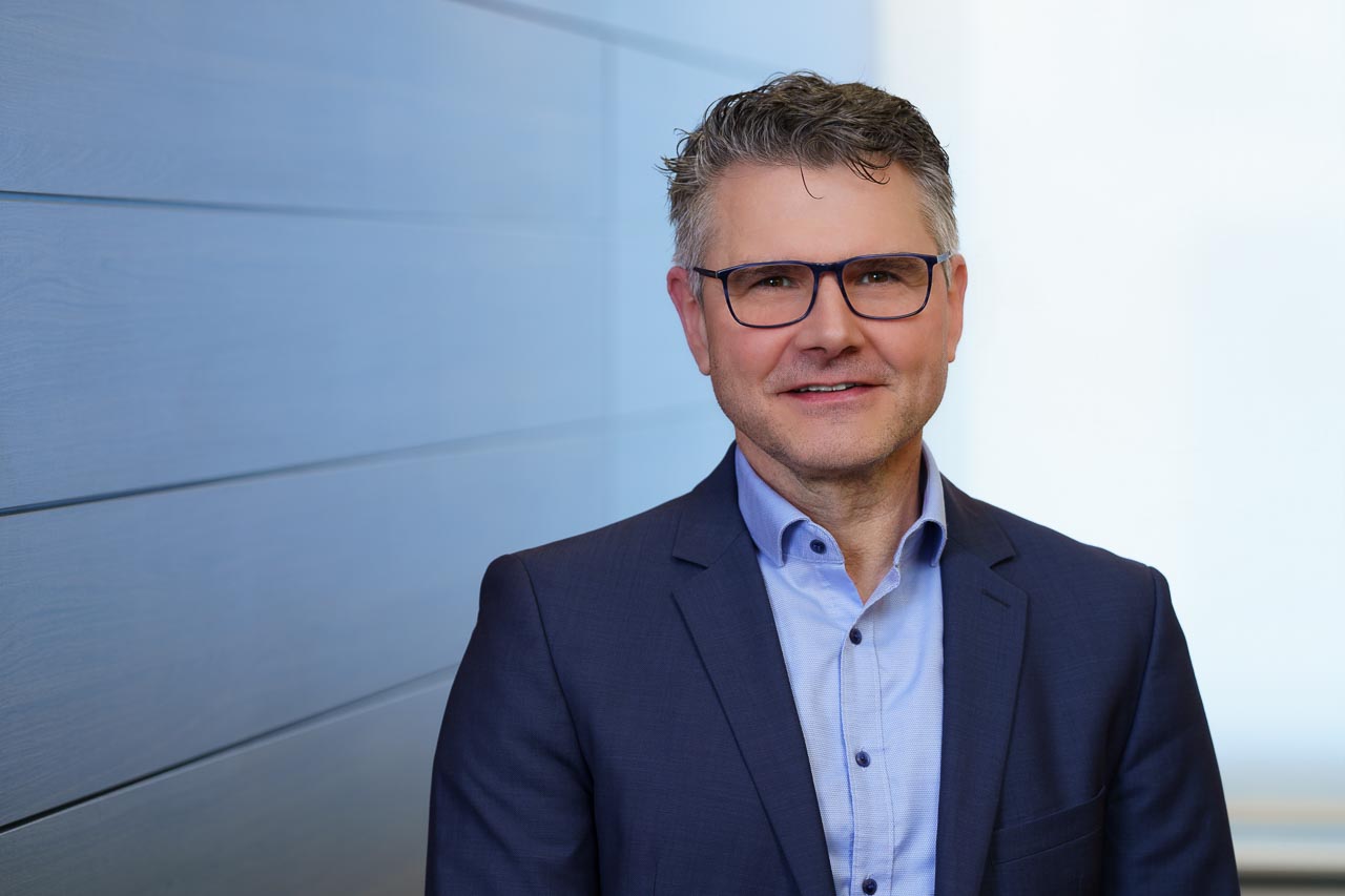 Businessfotografie Hamburg – professionelles Porträt eines Mannes im modernen Büro, seriös und authentisch inszeniert