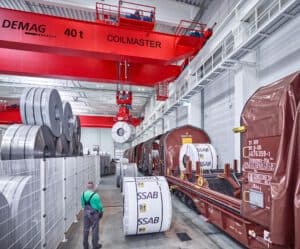 Stahl-Coil am Kran Kran transportiert schweren Stahl-Coil auf der Bahn