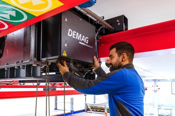 Anlagenbau Fotografie – Monteur bei Wartungsarbeiten an moderner Krananlage, präzise Darstellung industrieller Service- und Technikprozesse