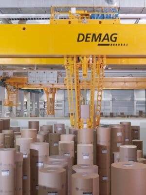 40240-4Papierlager mit Greifarm Greifarm bewegt Papierrollen im Lager – Industriefotografie von Erik Krüger.
